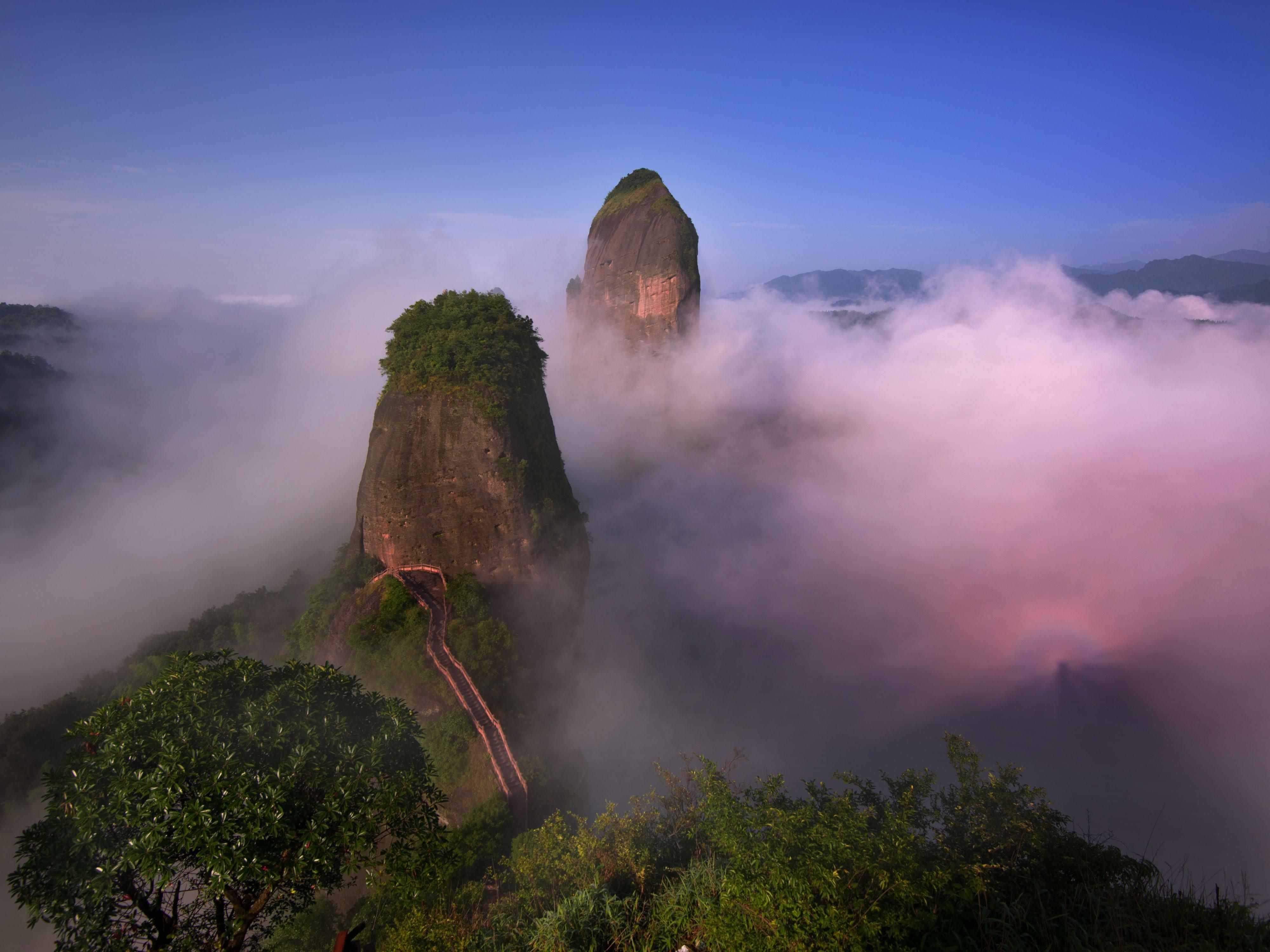 Sea of clouds rolling over Huangshan mountain peaks at sunrise, China