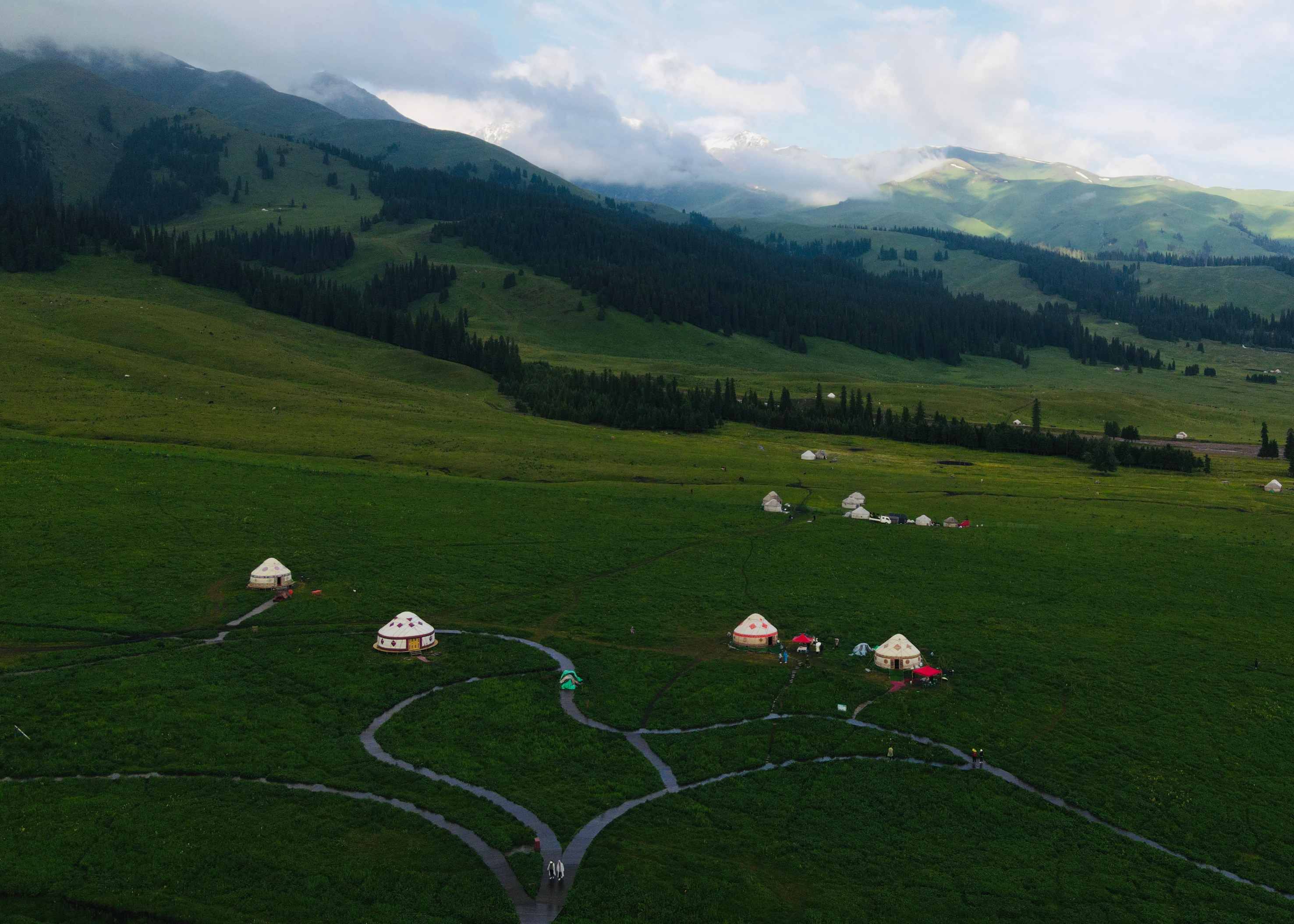 Traditional yurt on the grassland with mountain range in Xinjiang, China